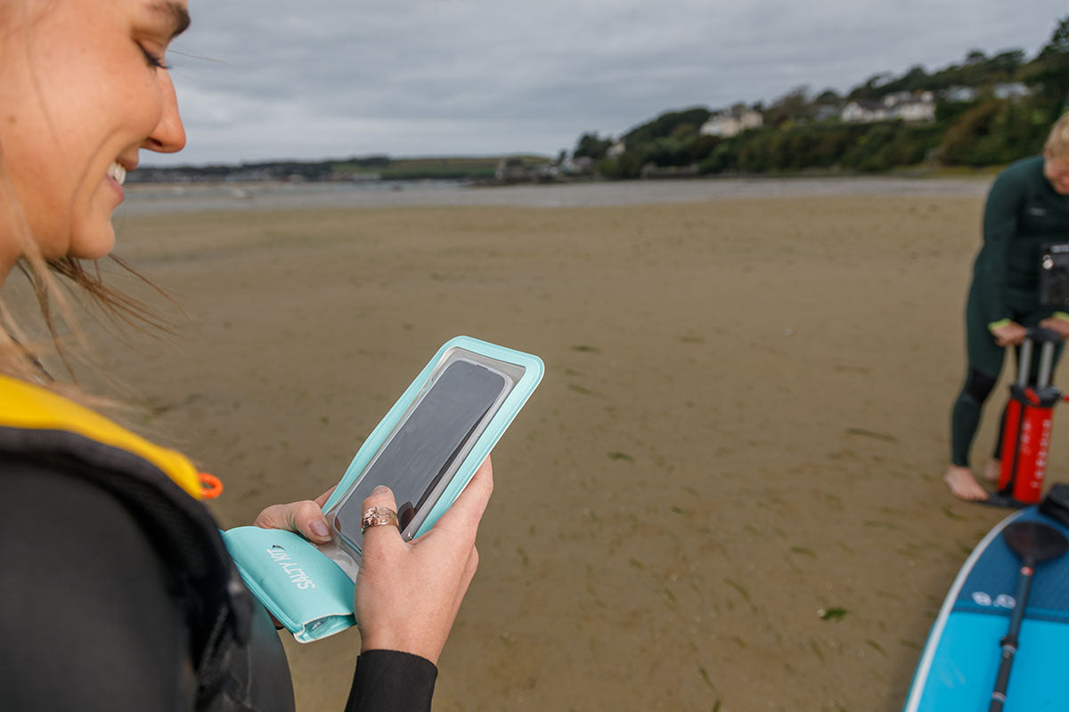 girl taking photo with her salty kit green phone pouch