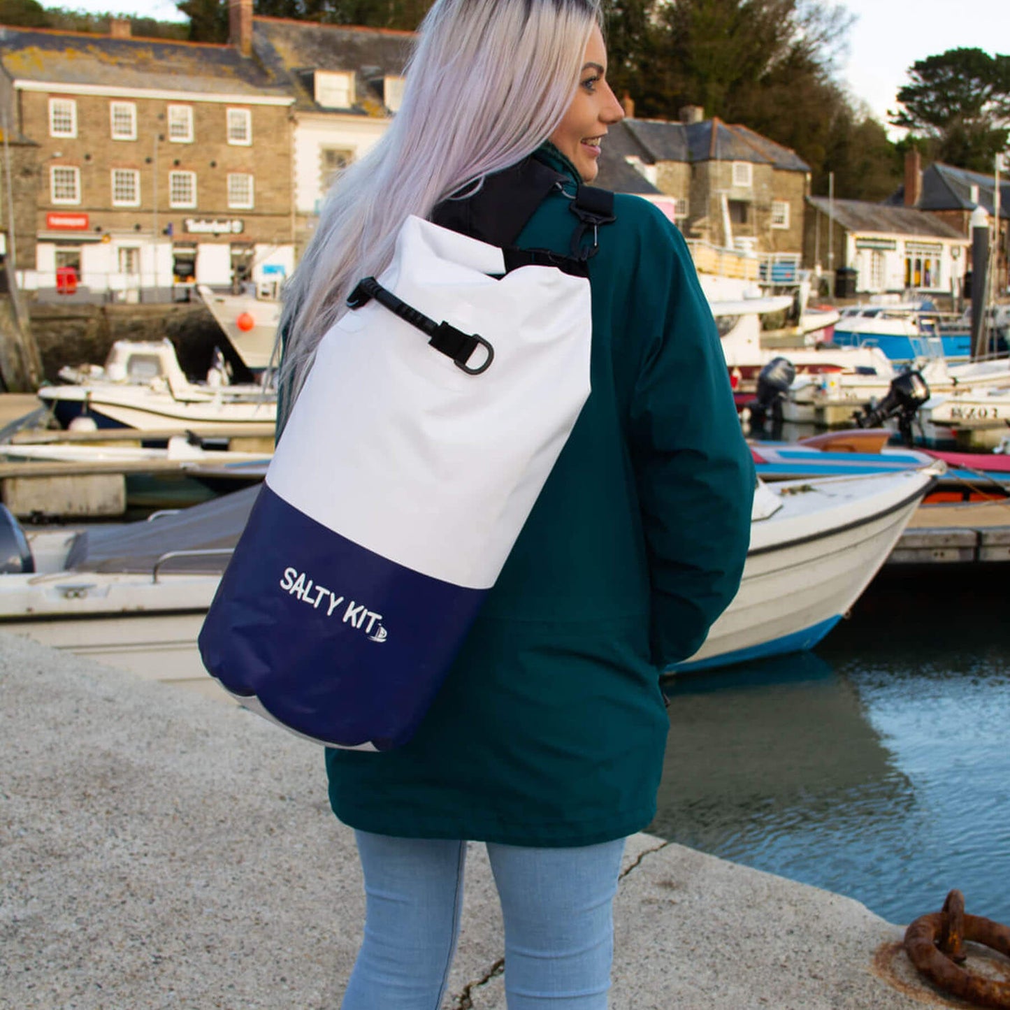 a girl standing in padstow harbour wearing a salty kit sailing bag