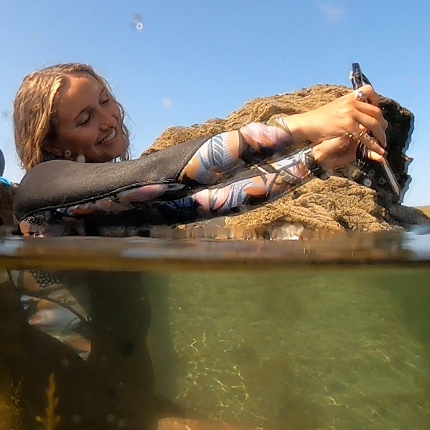 woman is taking a selfie using her salty kit waterproof black phone case