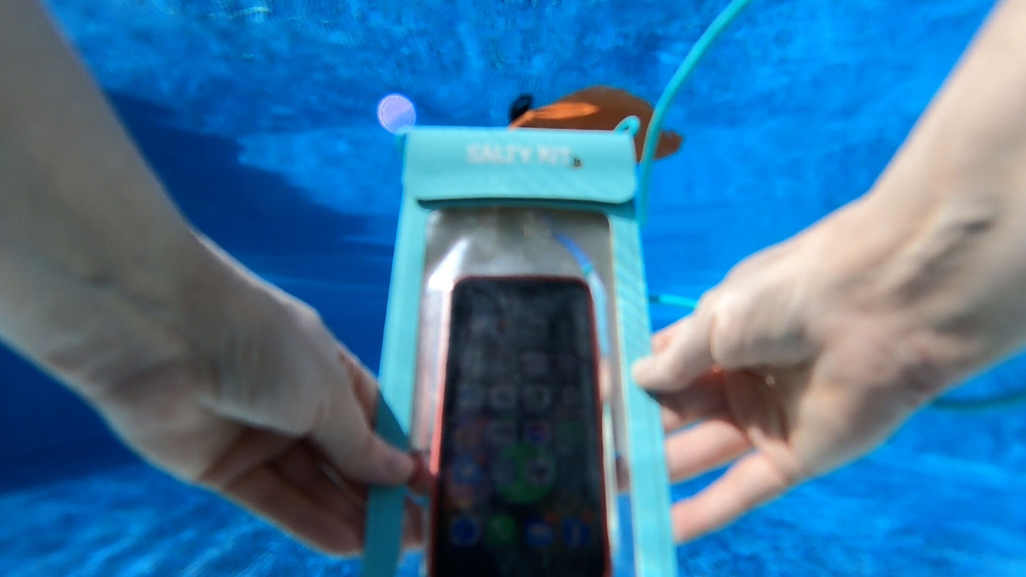 an image of a salty kit phone case in green in a swimming pool using the phone unnderwater