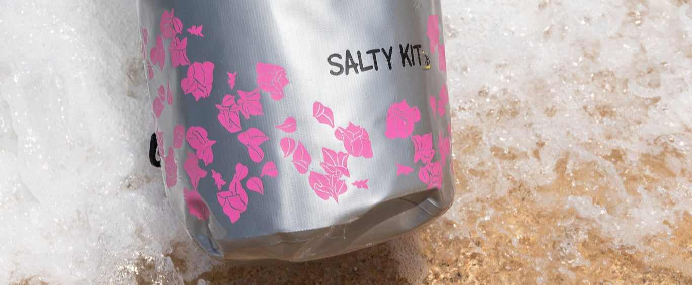 best waterproof stylish bags by salty kit the bag is being dipped in the sea with the 20 litre bougainvillea dry bag