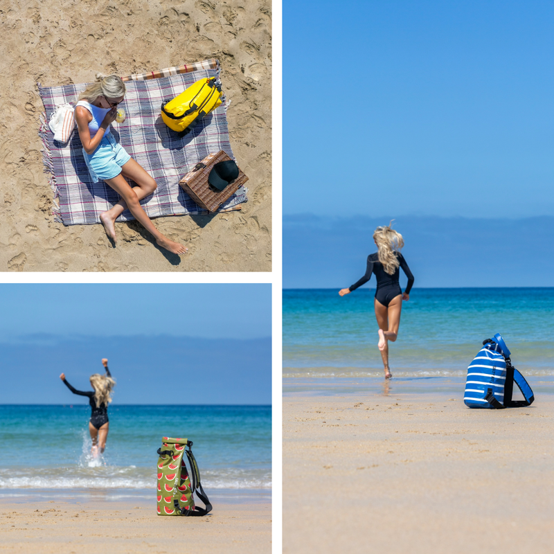 A three-panel collage showing beach lifestyle scenes: a woman relaxes on a plaid blanket with a yellow bag and hat on sand, a woman runs through shallow ocean water wearing a black swimsuit, and a blue-and-white striped beach bag sits on the sand beside the shoreline.