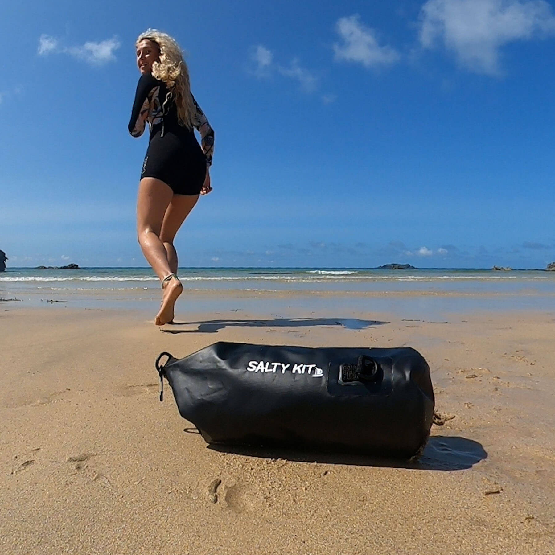 small dry bag ideal for swimming a girl is running into the sea