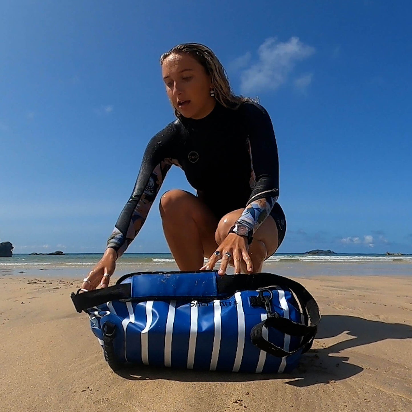 the best waterproof bag for swimming with comfort straps in a blue and white stripe nautical style 20 litre dry bag