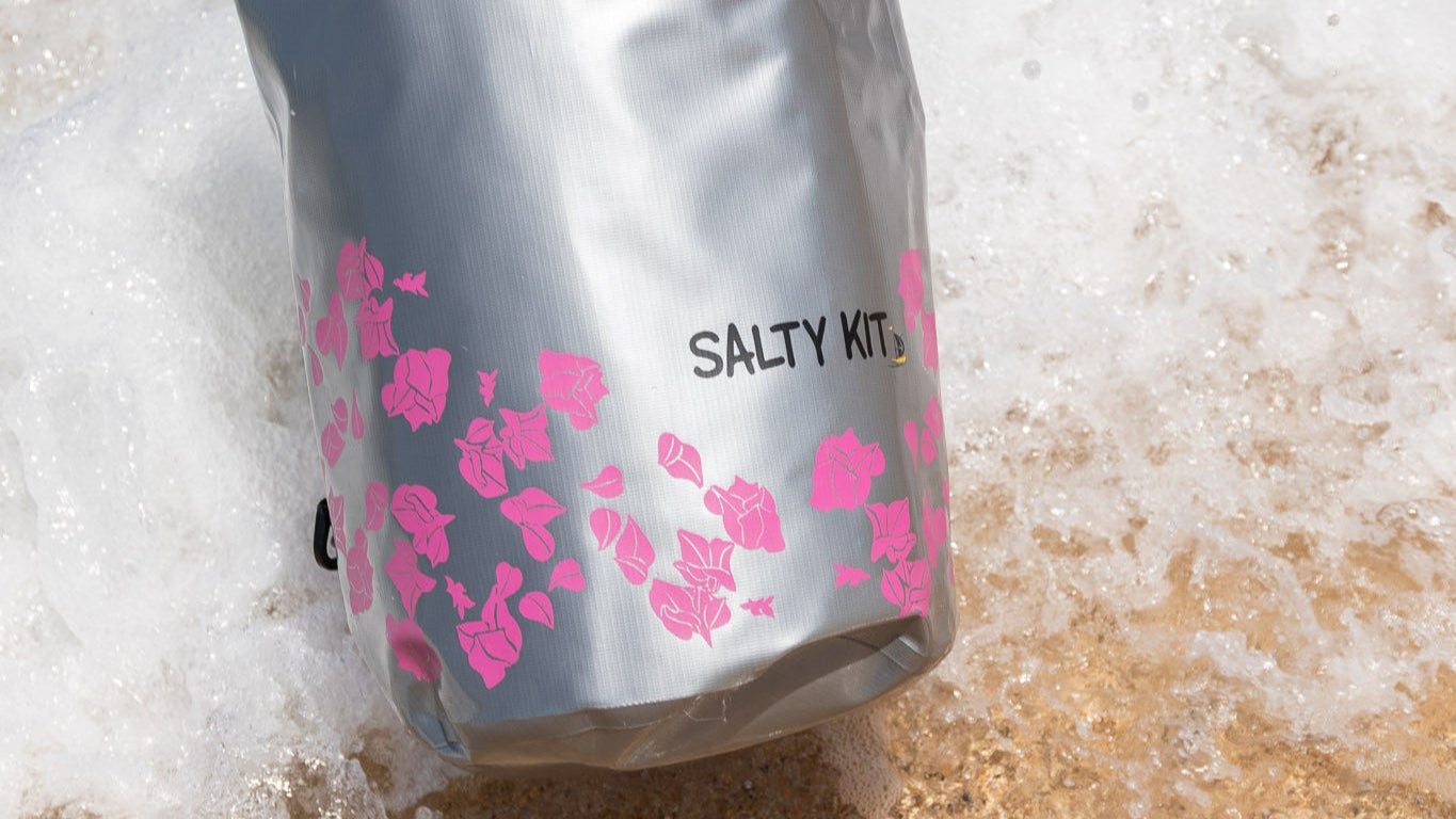 best waterproof stylish bags by salty kit the bag is being dipped in the sea with the 20 litre bougainvillea dry bag